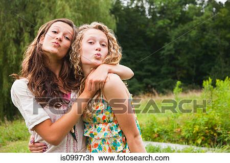 Teenage girls fooling around and puckering lips View Large Photo Image Stock Image - Teenage girls fooling around and puckering lips. Fotosearch