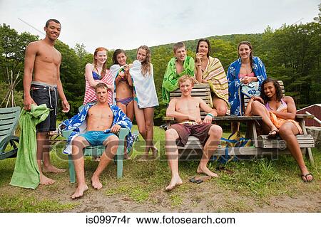 Teenagers chilling out together in swimming clothes in countryside View Large Photo Image Stock Photography - Teenagers chilling out together in swimming clothes in countryside. Fotosearch