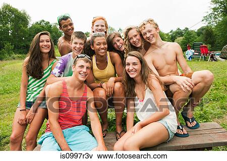 Stock Photo - Teenagers hanging out together in the countryside. Fotosearch