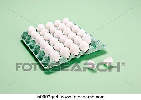 Broken egg next to egg carton View Large Photo Image Picture - Broken egg next to egg carton. Fotosearch