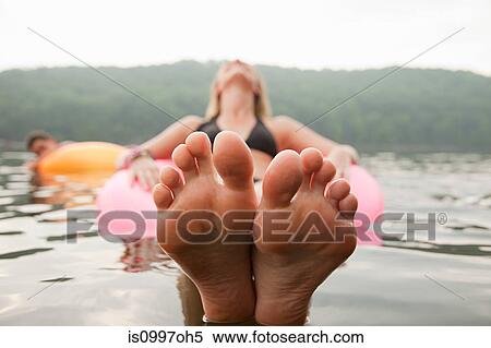 Close up of young woman floating in lake View Large Photo Image Stock Photography - Close up of young woman floating in lake. Fotosearch