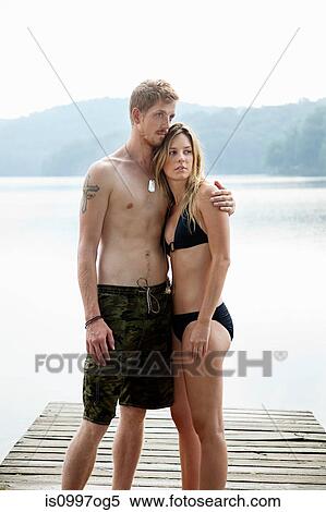 Couple standing on pier over lake View Large Photo Image Stock Photography - Couple standing on pier over lake. Fotosearch