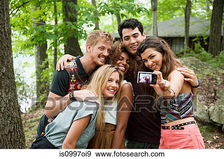 Friends posing in front of digital camera View Large Photo Image Stock Photo - Friends posing in front of digital camera. Fotosearch
