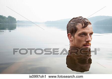 Mid adult man swimming in lake View Large Photo Image Stock Image - Mid adult man swimming in lake. Fotosearch
