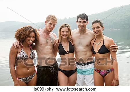 Portrait of friends standing in lake View Large Photo Image Stock Photo - Portrait of friends standing in lake. Fotosearch