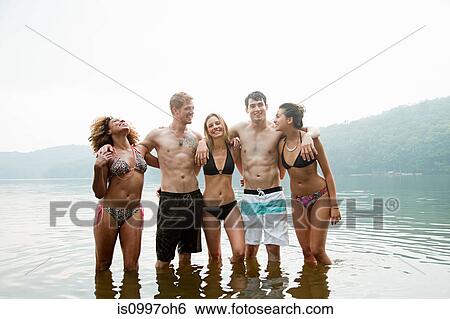 Portrait of friends standing in lake View Large Photo Image Stock Photograph - Portrait of friends standing in lake. Fotosearch