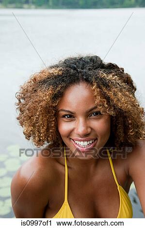 Portrait of young African American woman smiling View Large Photo Image Stock Image - Portrait of young African American woman smiling. Fotosearch