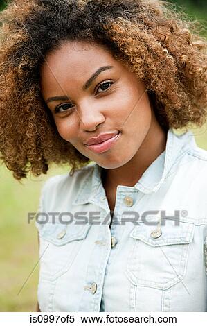 Stock Photography - Portrait of young African American woman smiling. Fotosearch