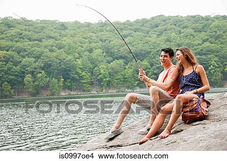 Young couple fishing at lake View Large Photo Image Picture - Young couple fishing at lake. Fotosearch