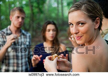 Young woman enjoying food in forest View Large Photo Image Stock Image - Young woman enjoying food in forest. Fotosearch