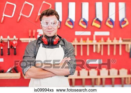 Carpenter front of wood work tools, portrait View Large Photo Image Stock Photograph - Carpenter front of wood work tools, portrait. Fotosearch
