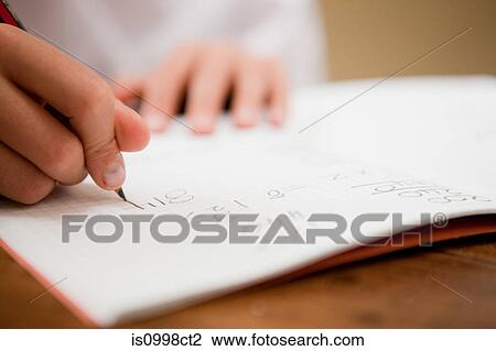 Close up of the hands of a young boy writing in a textbook View Large Photo Image Stock Image - Close up of the hands of a young boy writing in a textbook. Fotosearch