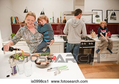 Family preparing meal together at home View Large Photo Image Stock Image - Family preparing meal together at home. Fotosearch