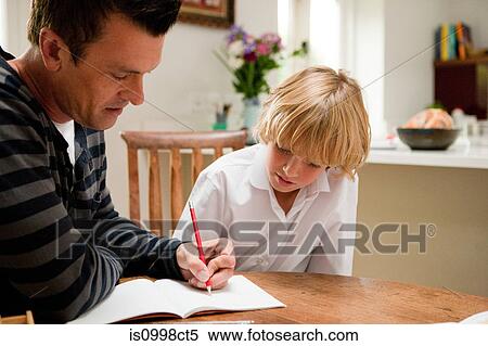 Father helping son with his homework View Large Photo Image Stock Photography - Father helping son with his homework. Fotosearch