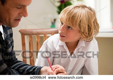 Picture - Father helping son with homework. Fotosearch