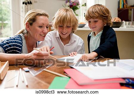 Mother helping older son with homework at the kitchen table View Large Photo Image Stock Image - Mother helping older son with homework at the kitchen table. Fotosearch