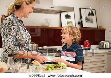 Son helping to carry napkins for mother, in preparation for meal View Large Photo Image Stock Image - Son helping to carry napkins for mother, in preparation for meal. Fotosearch
