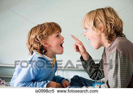 Two young boys quarrelling View Large Photo Image Stock Photography - Two young boys quarrelling. Fotosearch