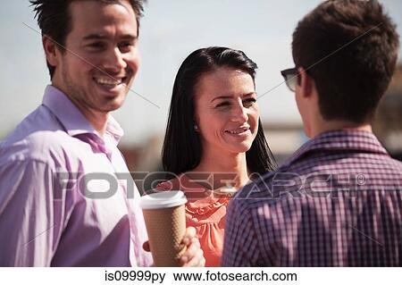 Stock Photo - Three friends having a chat over a coffee. Fotosearch