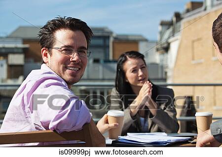 Three people in an outdoor meeting View Large Photo Image Stock Image - Three people in an outdoor meeting. Fotosearch
