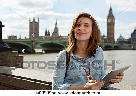 Young woman using a digital tablet in London View Large Photo Image Stock Photography - Young woman using a digital tablet in London. Fotosearch