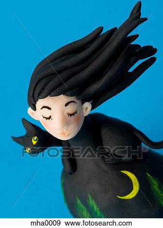 Stock Illustration - A sculpture of a woman in a Halloween costume. Fotosearch