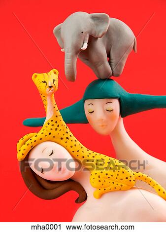 Clip Art - A sculpture of two women, an elephant and a leopard. Fotosearch
