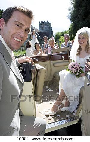 convertible bride cheering groom smiling portrait door background fotosearch