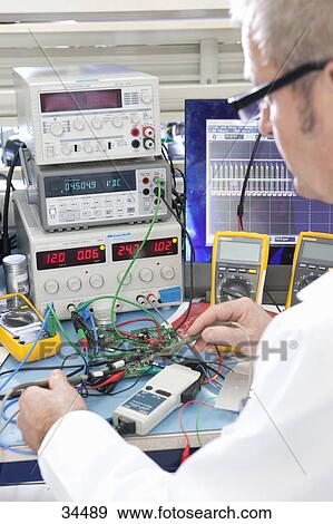 Engineer Working At Electrical Test Bench Stock Photo 34489