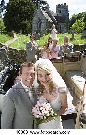 https://fscomps.fotosearch.com/compc/JCE/JCE121/bride-and-groom-by-vintage-car-wedding-stock-image__10863.jpg