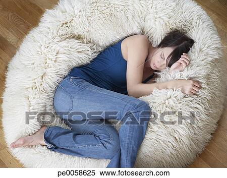 Woman On Furry Bean Bag Chair In Living Room Stock Photography