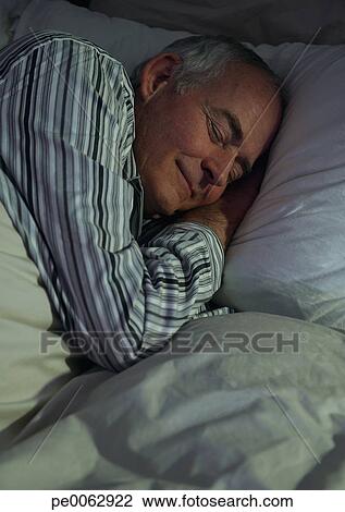Senior man sleeping in bed View Large Photo Image Stock Photo - Senior man sleeping in bed. Fotosearch - Search Stock Photography, Print Pictures, Images, and Photo Clip Art