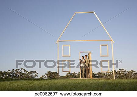 Picture - Couple in doorway of house outline. Fotosearch - Search Stock Photography, Photos, Prints, Images, and Photo Clipart