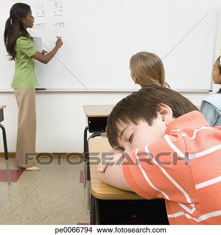 Boy Sleeping On Desk In Classroom Picture Pe0066794 Fotosearch