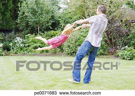 Father Swinging Daughter In Backyard Stock Image Pe0071683