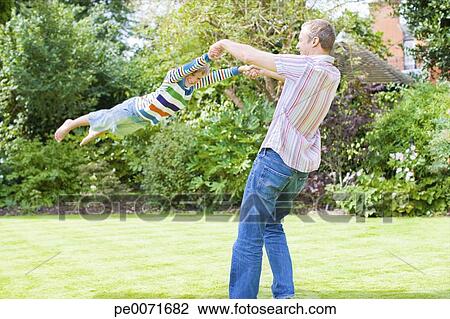 Father Swinging Son In Backyard Stock Image Pe0071682 Fotosearch