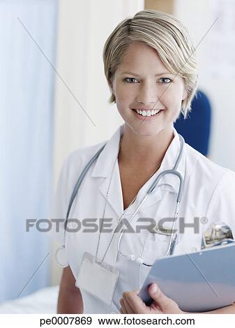 Nurse with clipboard in hospital View Large Photo Image Stock Photograph - Nurse with clipboard in hospital. Fotosearch - Search Stock Photography, Posters, Pictures, and Photo Clipart Images