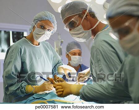 Stock Photography - Team of nurses and surgeons in surgery. Fotosearch - Search Stock Photos, Pictures, Prints, Images, and Photo Clip Art