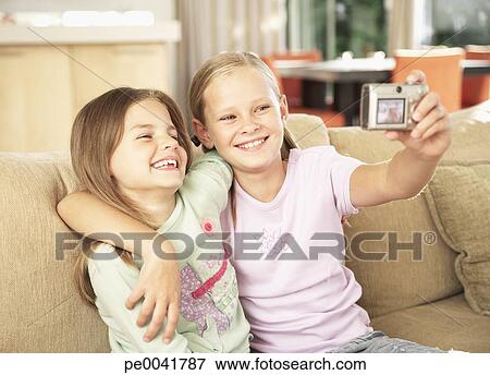 Two young girls taking a picture of themselves Stock Photo | pe0041787 ...