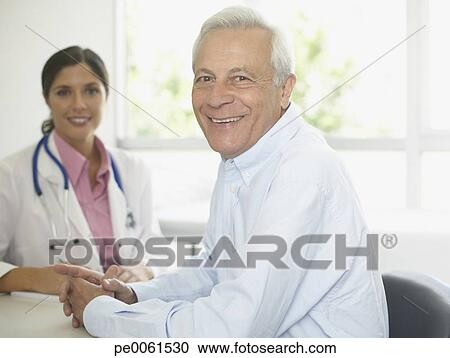 Stock Photography - Doctor and patient sitting in office smiling. Fotosearch - Search Stock Photos, Pictures, Wall Murals, Images, and Photo Clipart