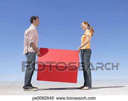 Stock Photograph - Couple holding small model house. Fotosearch - Search Stock Photography, Posters, Pictures, and Photo Clipart Images