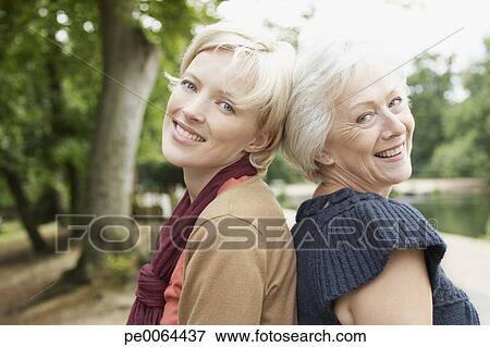 Senior mother and daughter near pond View Large Photo Image Picture - Senior mother and daughter near pond. Fotosearch - Search Stock Photography, Photos, Prints, Images, and Photo Clipart
