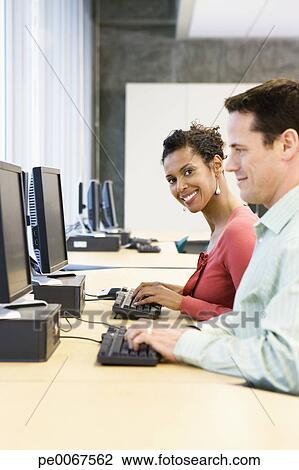 Business people using computers Stock Image | pe0067562 | Fotosearch