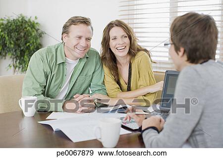 Stock Photograph - Couple meeting with financial advisor. Fotosearch - Search Stock Photography, Posters, Pictures, and Photo Clipart Images