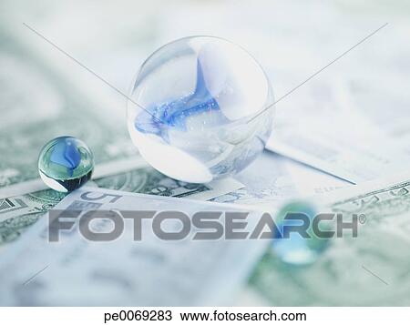 Stock Photo - Glass marbles on paper currency. Fotosearch - Search Stock Images, Poster Photographs, Pictures, and Clip Art Photos