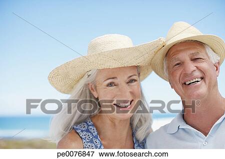 Picture - Senior couple on beach. Fotosearch - Search Stock Photography, Photos, Prints, Images, and Photo Clipart