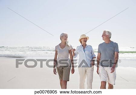 Senior friends walking on beach View Large Photo Image Stock Image - Senior friends walking on beach. Fotosearch - Search Stock Photos, Mural Pictures, Photographs, and Photo Clipart