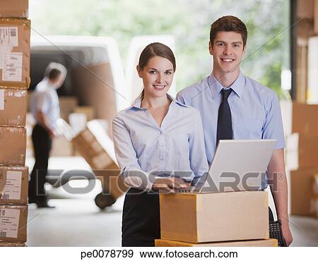 Stock Photograph - Business people working with laptop in warehouse. Fotosearch - Search Stock Photography, Posters, Pictures, and Photo Clipart Images