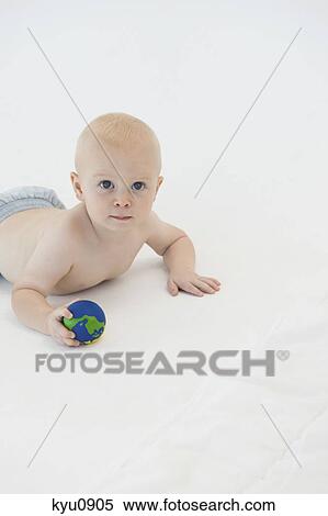 Baby boy holding a ball View Large Photo Image Stock Photography - Baby boy holding a ball. Fotosearch