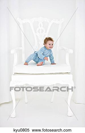 Baby boy sitting in an armchair View Large Photo Image Stock Photography - Baby boy sitting in an armchair. Fotosearch